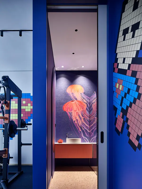 Pasillo azul con mosaico pixelado y mural de medusas al fondo en la casa de Viktor Viden